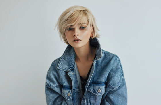 Portrait of fashion blonde woman with short messy hair wear denim jacket